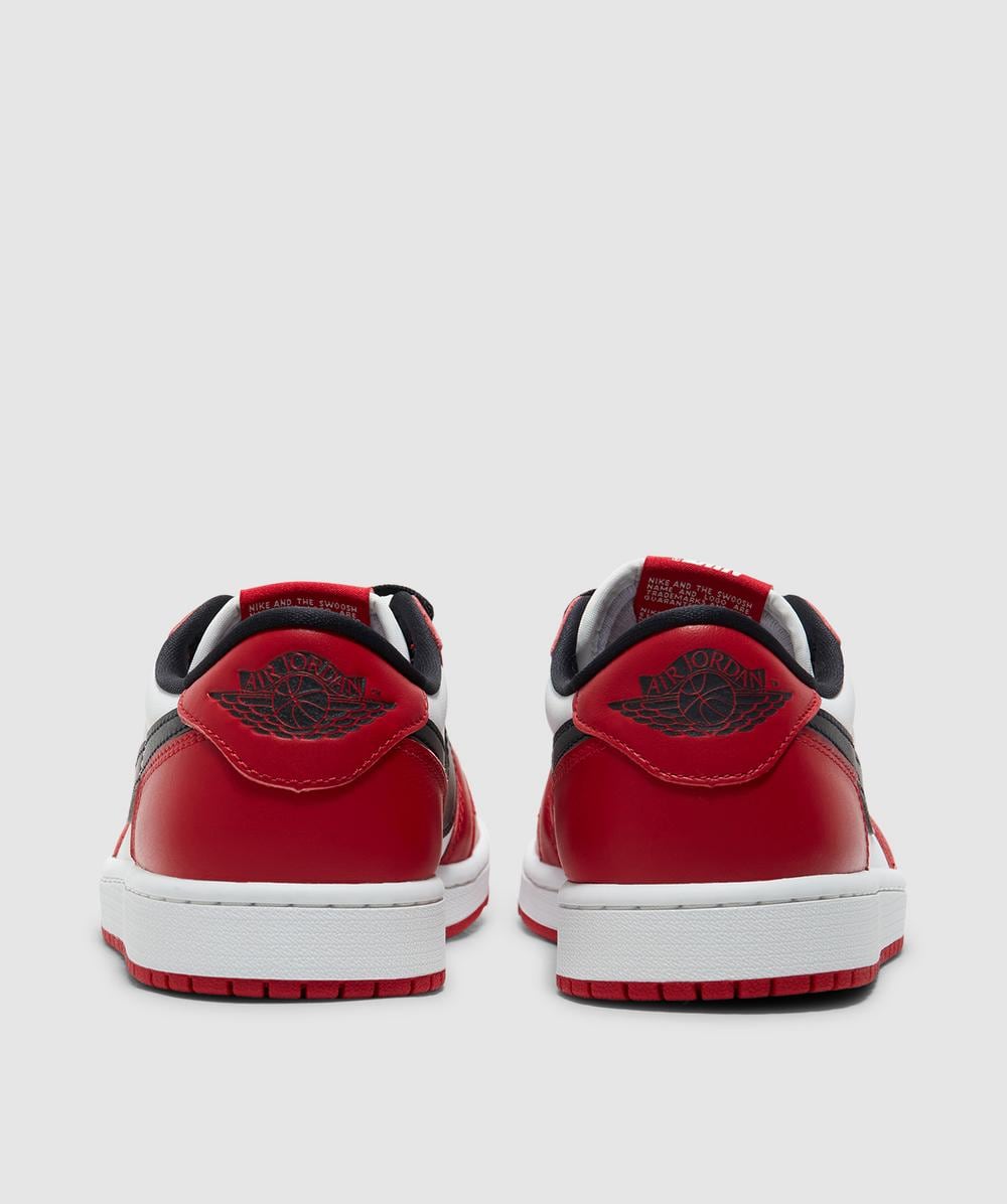 white and red low jordan 1