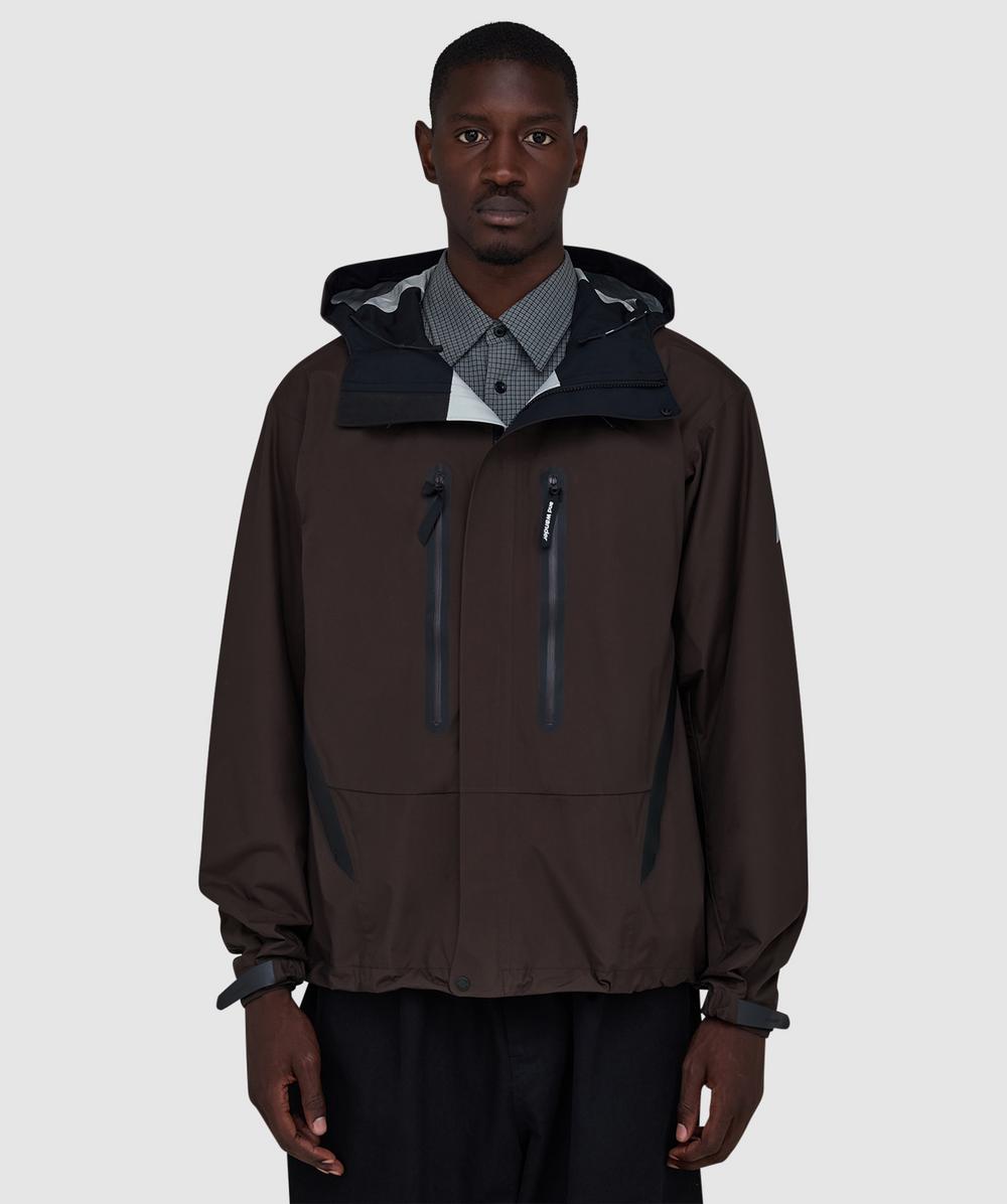 And Wander 2.5l Hiker Rain Jacket In Brown